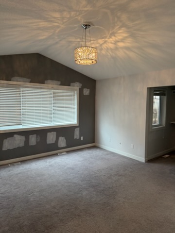 Bedroom with dark accent wall and patch repairs ready for repaint