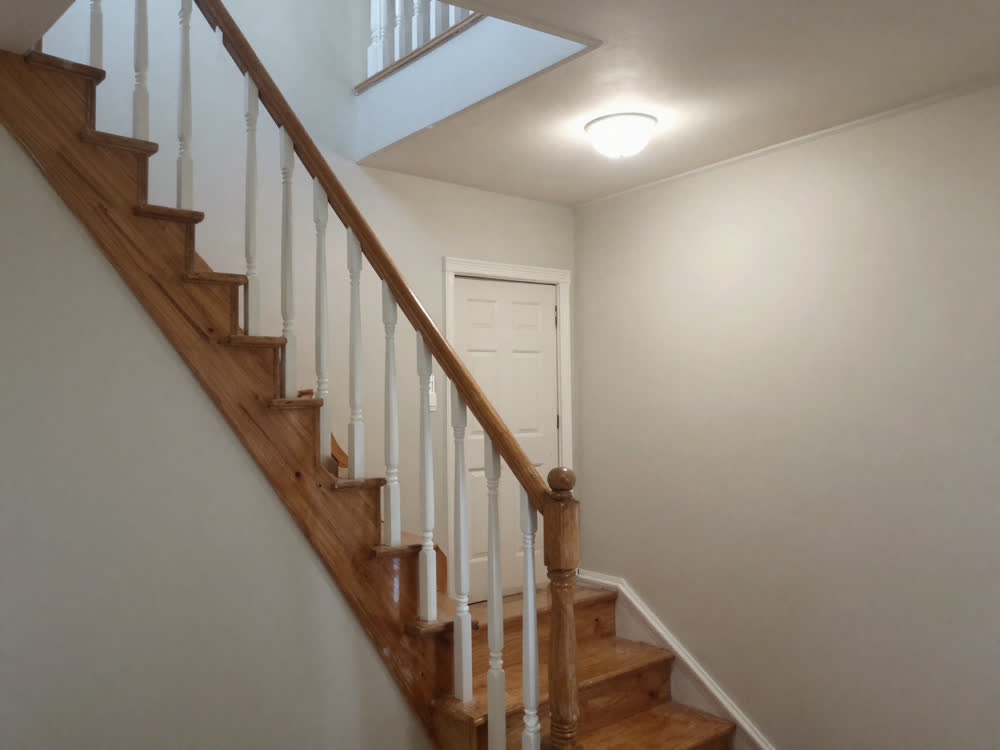 Interior staircase, landing and hallway with scuffed walls needing repaint
